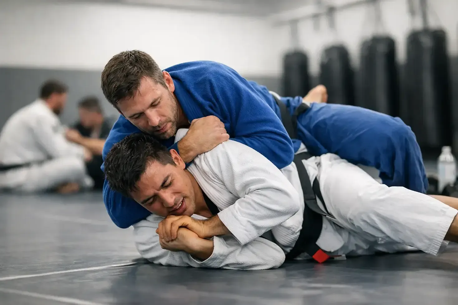 Students training Jiu-Jitsu in a demanding ground exercise