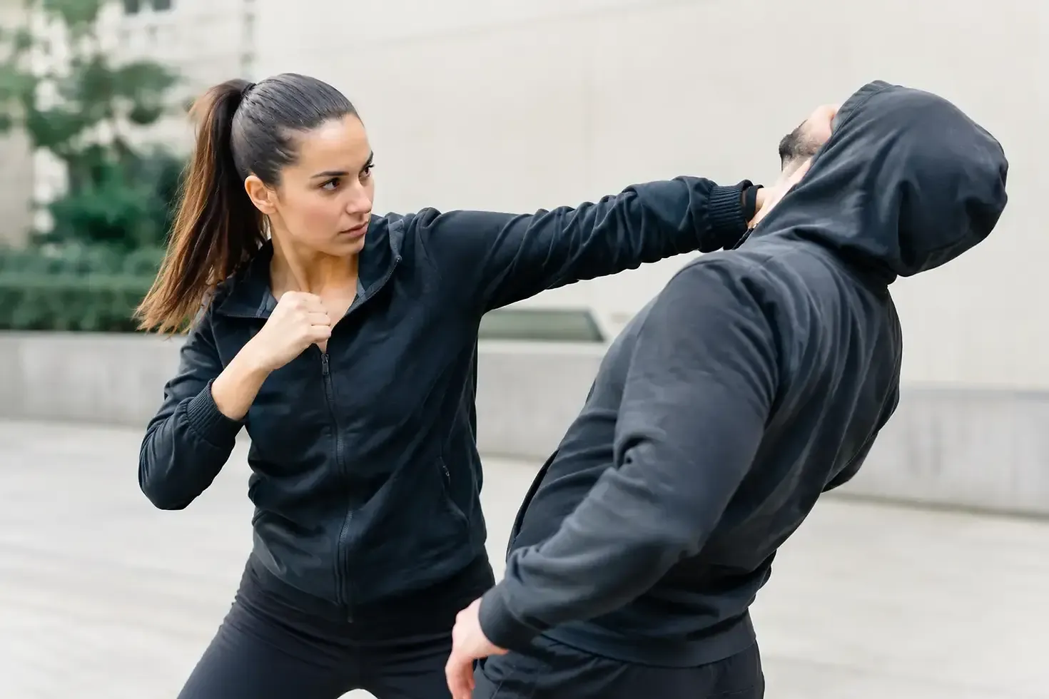 Adult self-defense partners practicing a controlled defensive technique
