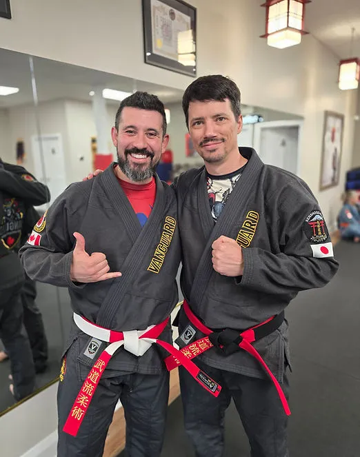 Vanguard instructors standing together in the dojo during youth confidence training