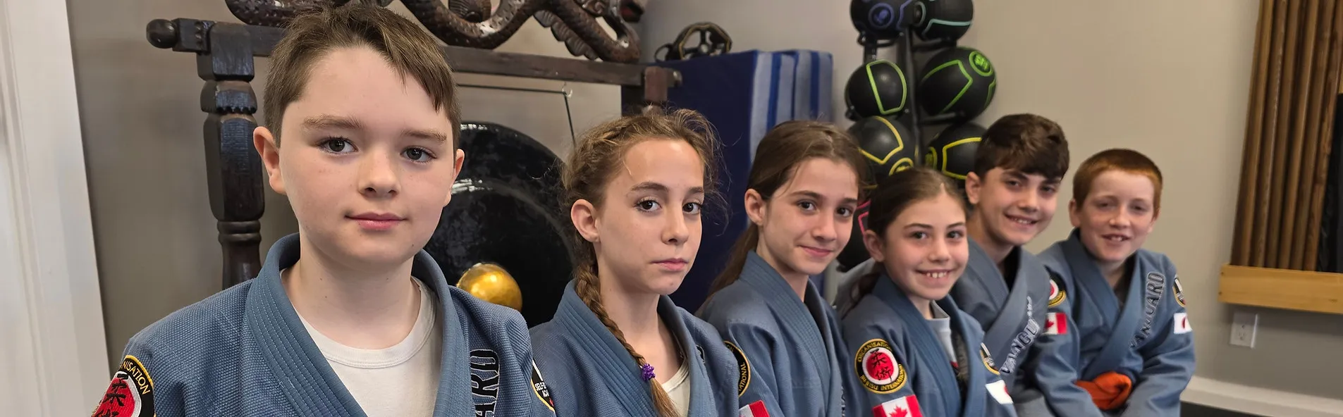 Kids in Vanguard gis building confidence together inside the dojo